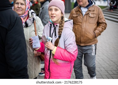 KYIV, UKRAINE - APR 20, 2022: A Happy Girl Who After Standing In A Long Line, Finally Bought A Stamp Russian Warship Go F..k, Dedicated To The Defeat Of Flagship Ru Black Sea Fleet, The Cruiser MOSCOW