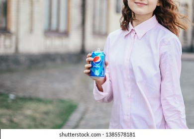 KYIV, UKRAINE - APRIL 04, 2019:Happy Girl Drink Pepsi 