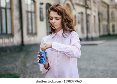 KYIV, UKRAINE - APRIL 04, 2019:Happy Girl Drink Pepsi 