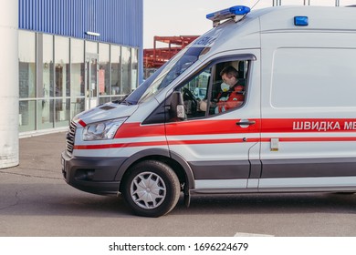 KYIV, UKRAINE - April 04. 2020. An Ambulance Driver Sits In A Protective Medical Mask Against The Virus.