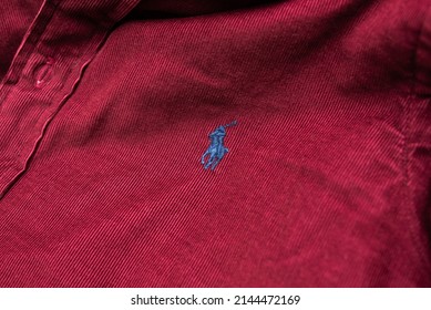 Kyiv, Ukraine - April 10, 2022: blue Polo Ralph Lauren logo on the crimson shirt