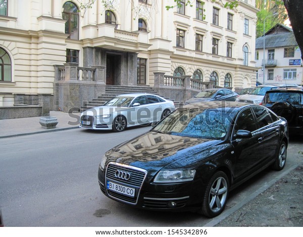Kyiv Ukraine - April 24, 2019: Beautiful scene with\
black and white cars. True modern cityscape of Ukrainian capital\
with expensive cars on the street. Real urban style of rich man.\
Great editorial 