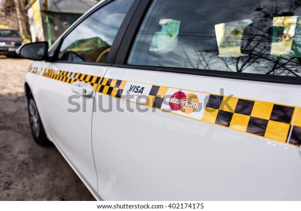 Kyiv, Ukraine - April 3th, 2016:Taxi car with\
VISA and Master-Card signs. In this taxi you can pay for your\
travel with a bank card (credit\
card)\
