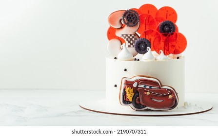 KYIV, UKRAINE - August 01: Birthday Cake With Gingerbread Cookie In The Shape Of Lightning McQueen Car Character Of Animated Pixar Film Series. White Cake With Red Edible Race Car