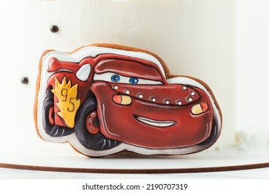 KYIV, UKRAINE - August 01: Birthday Cake With Gingerbread Cookie In The Shape Of Lightning McQueen Car Character Of Animated Pixar Film Series. White Cake With Red Edible Race Car