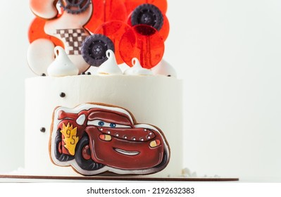 KYIV, UKRAINE - August 01: Birthday Cake With Gingerbread Cookie In The Shape Of Lightning McQueen Car Character Of Animated Pixar Film Series. White Cake With Red Edible Race Car