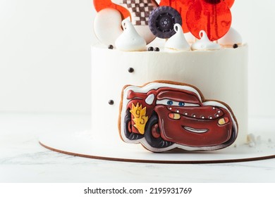 KYIV, UKRAINE - August 01: Birthday Cake With Gingerbread Cookie In The Shape Of Lightning McQueen Car Character Of Animated Pixar Film Series. White Cake With Red Edible Race Car