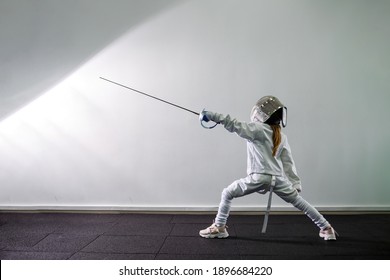 KYIV, UKRAINE - August 2020: Children lunge on swords. A child in a class at a fencing school