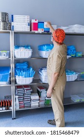 KYIV, UKRAINE - August 2020: Closet With Shelves Of Various Medical Equipment And Supplies At A Hospital. Sanitizer. Stocked Shelves Of Medical Scrubs. Assistant Chooses Stuff.