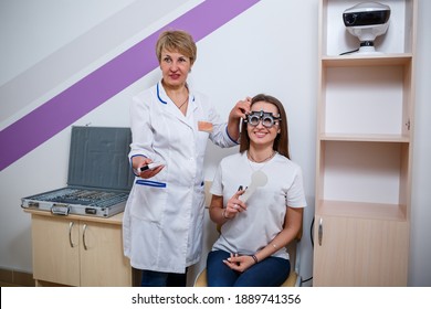 KYIV, UKRAINE - August 2020: Young Beautiful Woman At The Ophthalmologist's Appointment Checks Her Eyesight. Doctor Ophthalmologist Examines The Patient