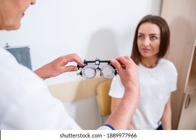 KYIV, UKRAINE - August 2020: Young Beautiful Woman At The Ophthalmologist's Appointment Checks Her Eyesight. Doctor Ophthalmologist Examines The Patient