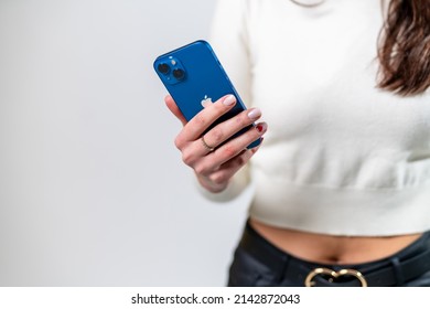 KYIV, UKRAINE - August 2021: New apple iphone in woman hands. Fit woman holding iphone.