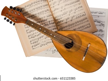 Kyiv, Ukraine - Circa 2016: Vintage Mandolin On A Background Of Open Sheet Music Book.