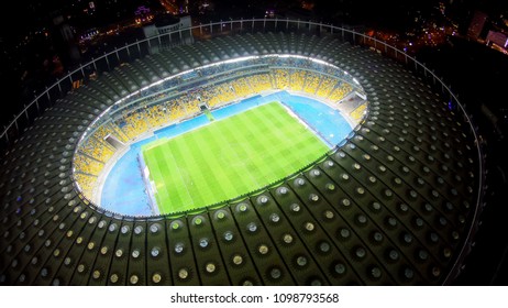 KYIV, UKRAINE - CIRCA APRIL 2018: Olympiysky Sports Complex. Huge Sports Arena Illuminated With City Lights, Competition Place, Aerial View
