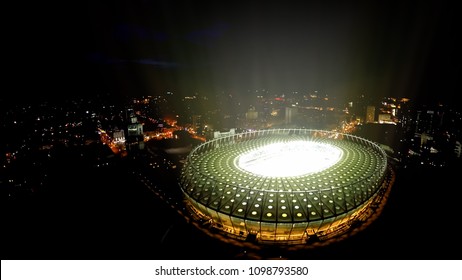 KYIV, UKRAINE - CIRCA APRIL 2018: Olympiysky Sports Complex. Illuminated Modern Stadium, Lights Sparkling In Night Megalopolis, Aerial View
