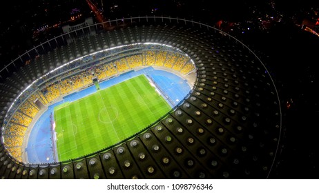 KYIV, UKRAINE - CIRCA APRIL 2018: Olympiysky Sports Complex. Football Players On Large Stadium Field, Sport Match, Illuminated Landmark
