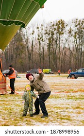 Kyiv, Ukraine - Dec 20 2020: Father Or Grandfather Shows To A Little Kid To The Sky With Index Finger Point Up. Hot Air Ballon Festival. Outdoor. Park. City. Family. Relationship