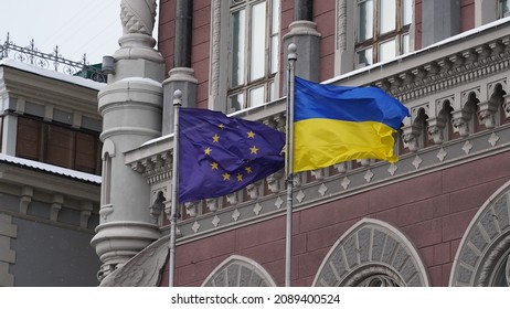 KYIV, UKRAINE - DECEMBER 10, 202: The European Union flag and the Ukrainian flag are waving on the flagpole near the National Bank of Ukraine. - Shutterstock ID 2089400524
