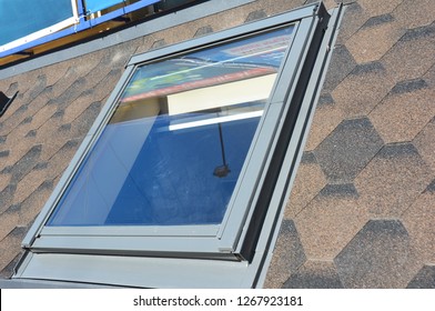 KYIV, UKRAINE - December, 27, 2018: Close Up On Attic Skylight Window Repair With Waterproofing Membrane On Asphalt Shingles Roof. Roofing Construction.