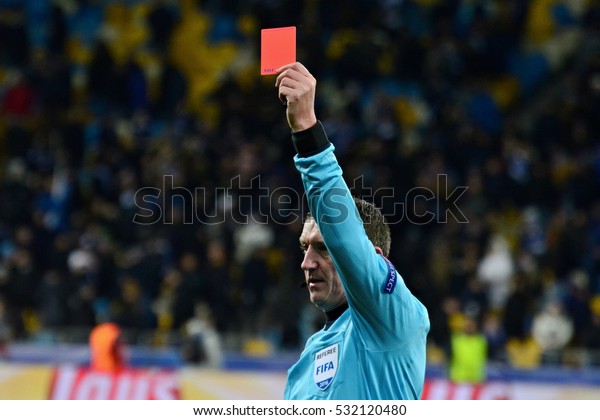 KYIV, UKRAINE -\
DECEMBER 6, 2016: The referee shows a red card during the UEFA\
Champions League football match between FC Dynamo Kyiv and Besiktas\
at the Olympiyski Stadium