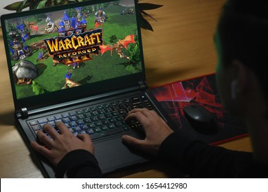 Kyiv, Ukraine; Feb 20, 2020: The guy plays on the notebook in WARCRAFT III: REFORGED.