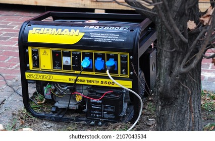 KYIV, UKRAINE - JANUARY, 02, 2022: A Close-up Of A Gas Portable Backup Generator Supplying Power Outdoors. A Small Mobile Gas Generator For Camping.