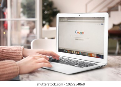 KYIV, UKRAINE - JANUARY 15, 2018: Woman Using Apple Macbook Air With Google Search Page On Screen At Table In Cafe