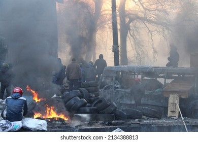 Kyiv, Ukraine - January 24 2014: Riots in the city. Citizens in conflict with the power. Protesters harness tires and vehicles. Police disperse demonstrators. People fighting for their rights.