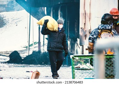 Kyiv, Ukraine - January 25, 2014:Protesters In Kyiv. Man Carrying A Sandbag