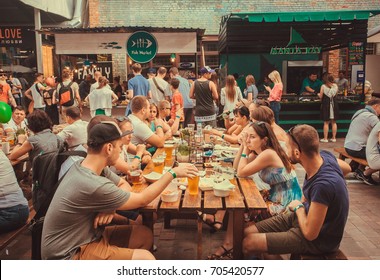 KYIV, UKRAINE - JUL 23: Friendly Party With Crowd Of  People Eating At Table During Outdoor Street Food Festival On July 23, 2016. Kiev Is The 8th Most Populous City In Europe.