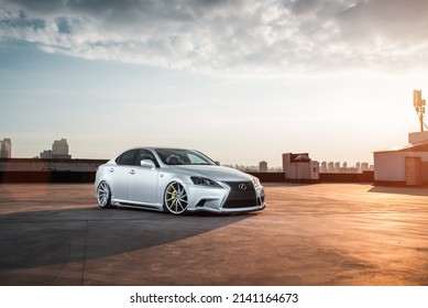 Kyiv, Ukraine - July 03 2016: Silver Lexus IS Sedan Parked On Top Level Of Parking Garage. City Skyline In  The Background