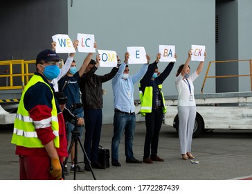 KYIV, UKRAINE - JULY 08, 2020: Boeing 737 800 Flydubai first flight in Kyiv Boryspil airport. People holding Welcome back signs