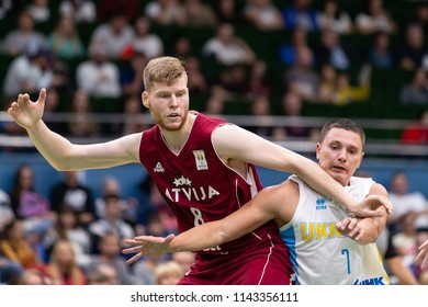 KYIV, UKRAINE - JULY 1, 2018: Davis Bertans and Denys Lukashov portraits fighting for the ball. FIBA World Cup 2019 European Qualifiers match Ukraine-Latvia