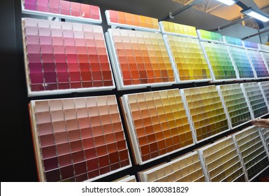 Kyiv, Ukraine - July 13, 2020:  A Customer Is Choosing The Right Interior Paint Color Using The Paint Color Palette In The Store.