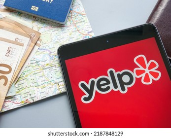 KYIV, UKRAINE - July 21, 2022. Yelp Inc Logo Near A Map And Money.