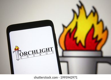 KYIV, UKRAINE - JULY 23, 2021: In this photo illustration Torchlight Energy Resources, Inc. logo is seen on a mobile phone and a computer screen.
