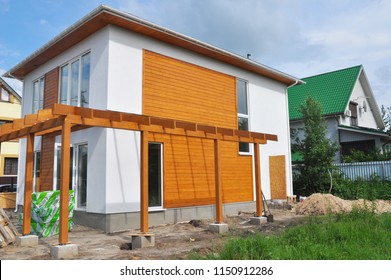 KYIV, UKRAINE - July, 31, 2018: Unfinished modern house construction with terrace patio and stack insulation materials. - Shutterstock ID 1150912286