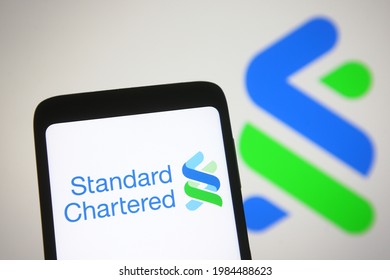 KYIV, UKRAINE - JUNE 02, 2021: In this photo illustration Standard Chartered plc logo of a British multinational banking and financial services company is seen on a mobile phone screen.