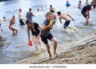 KYIV, UKRAINE - JUNE 19: During The Summer Heat Near Three Hundred Youth People Staged A Water Battle In The Center Of Kyiv On The Venetian Island Near The River Of Dnieper.