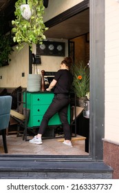 Kyiv, Ukraine - June 2 2022: Restaurant Waitress Busy At A Cash Desk