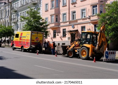 Kyiv, Ukraine - June 22 2022: Utility Truck, Tractor And Group Of Workers On The Road