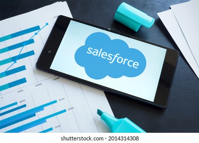 KYIV, UKRAINE - June 30, 2021. Salesforce logo on the smartphone and papers.