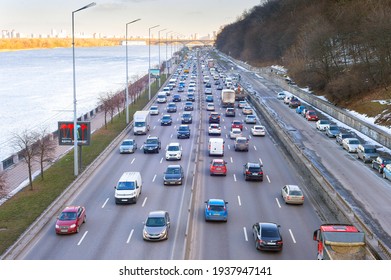 KYIV, UKRAINE - MARCH 03, 2021: Traffic on embankment road at sunset. Kyiv is the capital of Ukraine
