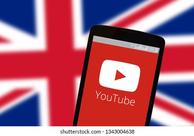 KYIV, UKRAINE - MARCH 19, 2019: The image of the logo of Youtube in the phone screen on the background of the flag of Great Britain