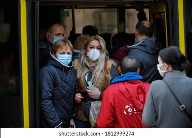 KYIV, UKRAINE- March 19, 2020: People Some Of Them In Wearing Face Masks As A Precaution Against The Spread Of Coronavirus Enter A Crowded Bus.