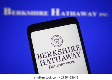 KYIV, UKRAINE - MARCH 19, 2021: In this photo illustration Berkshire Hathaway logo of an American multinational conglomerate is seen on a mobile phone and a computer screen.