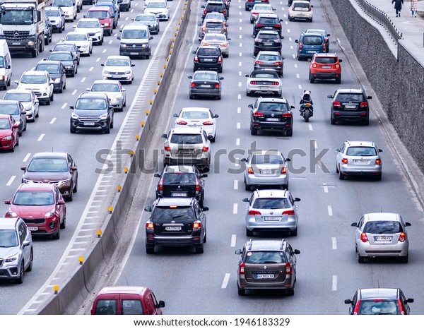 Kyiv,\
Ukraine - March 26, 2020: Sports bike rides through a stream of\
cars along a three-lane road in the city\
center
