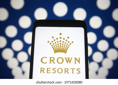 KYIV, UKRAINE - MAY 10, 2021: In This Photo Illustration Crown Resorts Limited Logo Is Seen On A Mobile Phone And A Computer Screen.