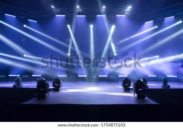 Kyiv, UKRAINE - May, 12 2020: Online concert.\
Event entertainment concept. Background for online concert. Blue\
stage spotlights. Empty stage with blue spotlights. Live streaming\
COVID-19 concert.