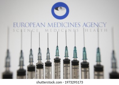 
KYIV, UKRAINE - MAY 13, 2021: In this photo illustration European Medicines Agency (EMA) logo is seen behind of medical syringes.